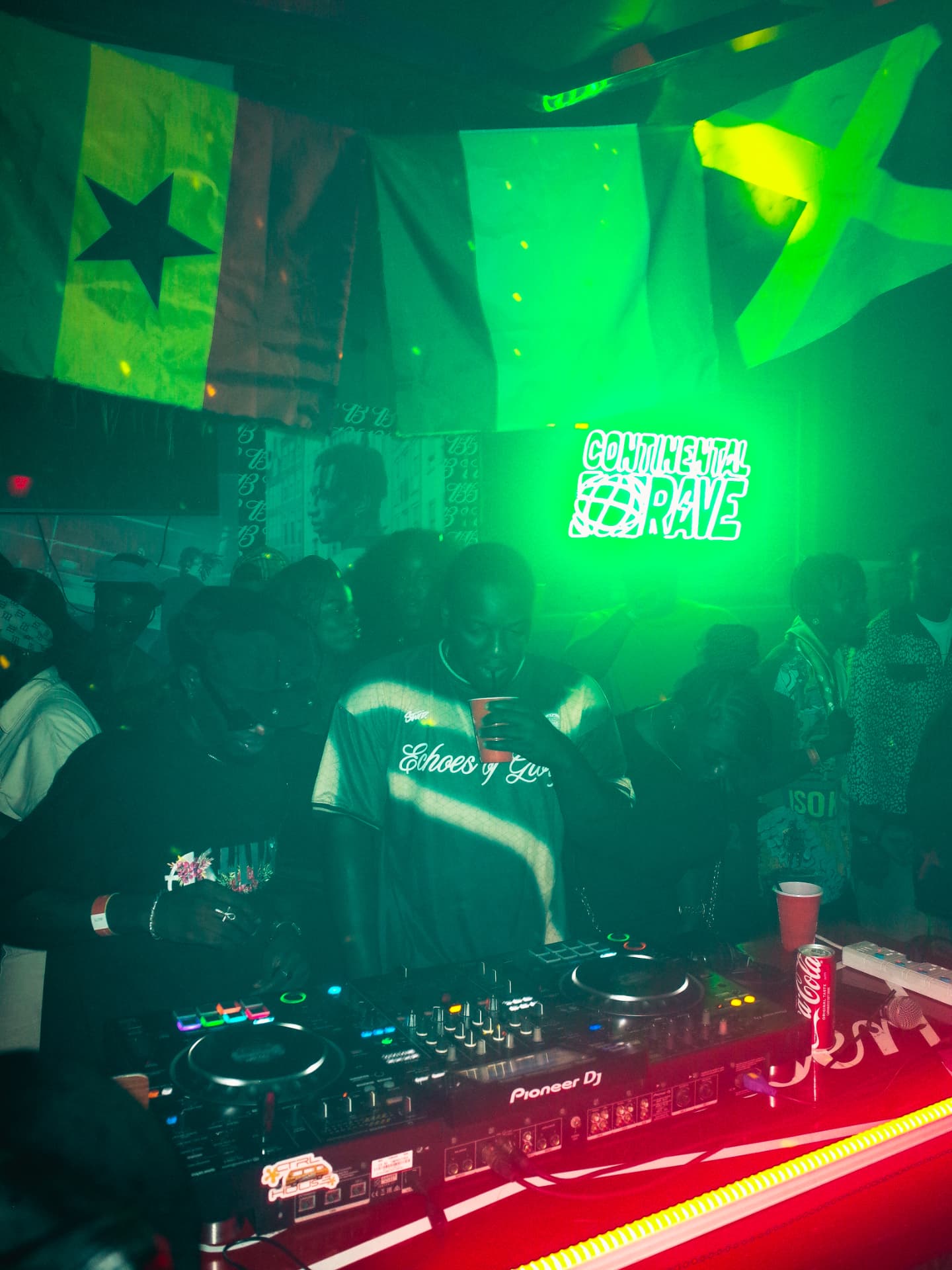 The deck with flags and the Continental Rave sign glowing behind
